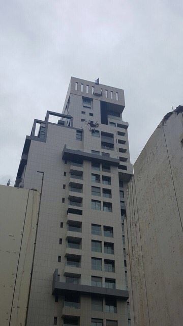 A crane in syoufi near Achrafieh fell because of strong wind damaging cars and balconies near by