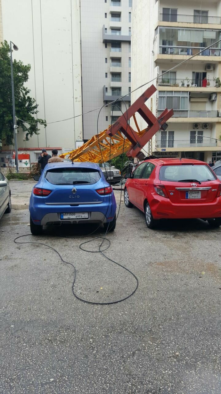 A crane in syoufi near Achrafieh fell because of strong wind damaging cars and balconies near by