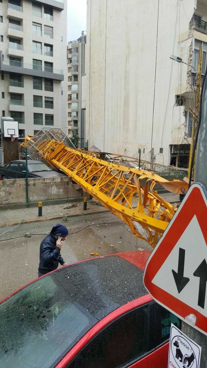 A crane in syoufi near Achrafieh fell because of strong wind damaging cars and balconies near by