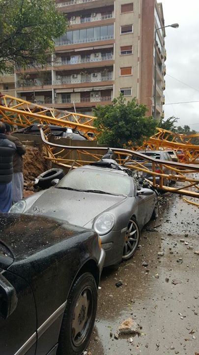 A crane in syoufi near Achrafieh fell because of strong wind damaging cars and balconies near by