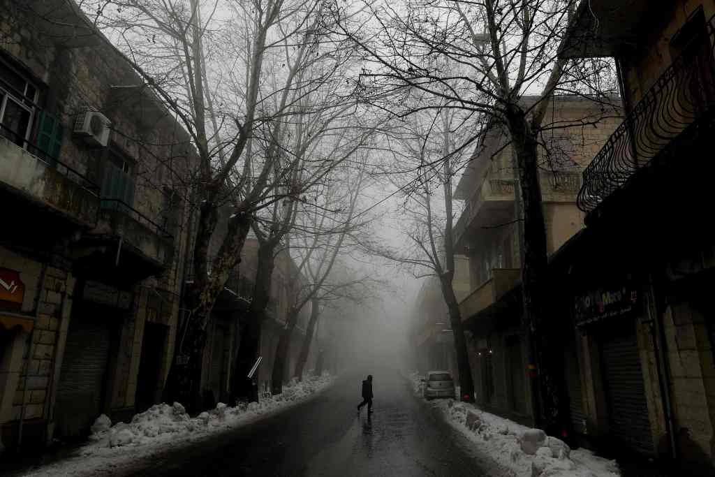 A man walks through the blizzard in Sawfar. (JOSEPH EID / AFP)