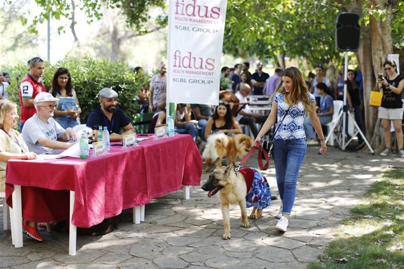 A woman shows off her dog to the judges during the 10th annual Dog Show in Beirut, Lebanon. (Hassan Ammar / AP)