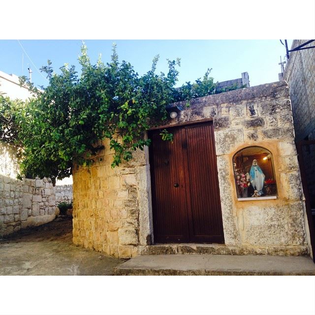 Classic house and a window display of Virgin Mary.