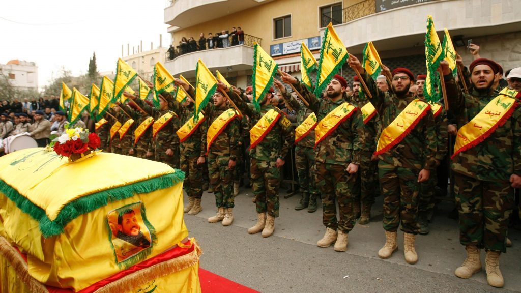 Fighters of Hezbollah attend the funeral of a comrade who died in Syria in Kfar Hatta. (Mahmoud Zayyat / AFP) via pow.photos