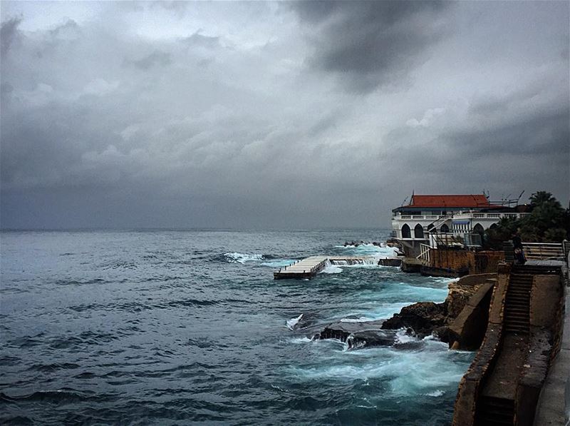 Huge waves crash on the sea defense wall of a restaurant, at the Beirut...