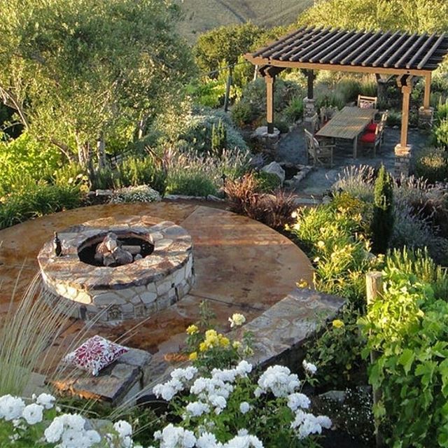 Outdoor living with a pergola , fire pit and landscape lighting. ... (Koura)