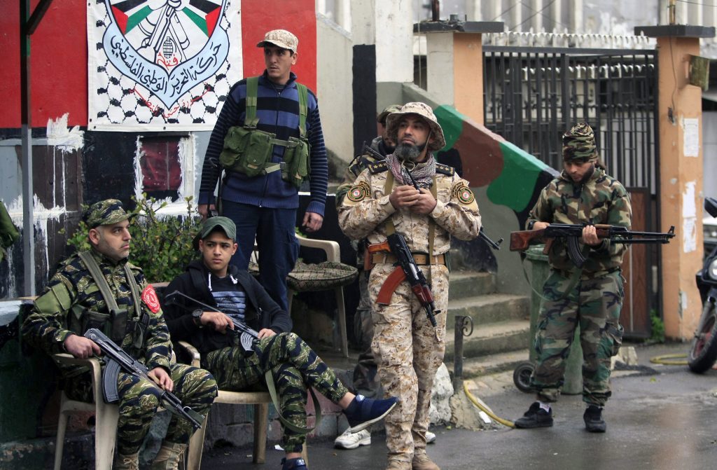 Palestinian gunmen from the Fatah movement, hold their weapons in the Ein el-Hilweh refugee camp. (Mohammed Zaatari / AP) via pow.photos