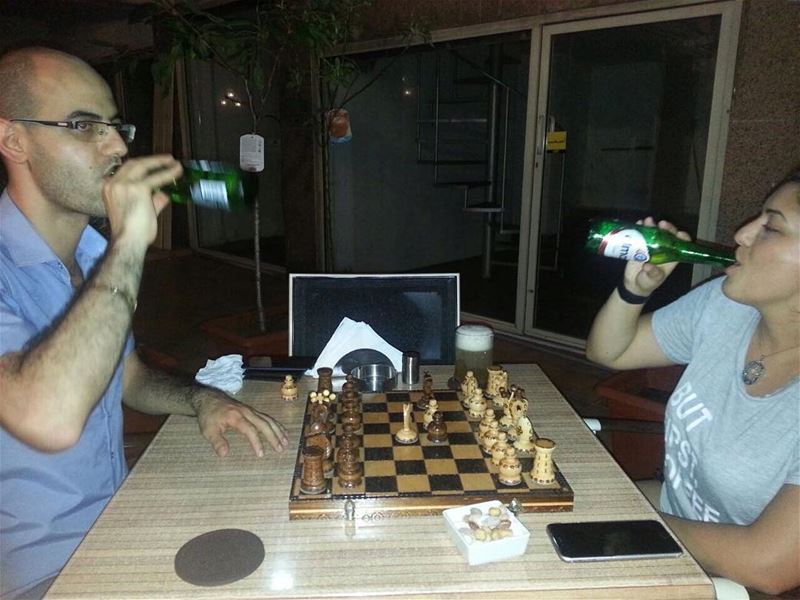 The loveliest people playing with Em's hand crafted Chess board! cheers! ... (Em's cuisine)