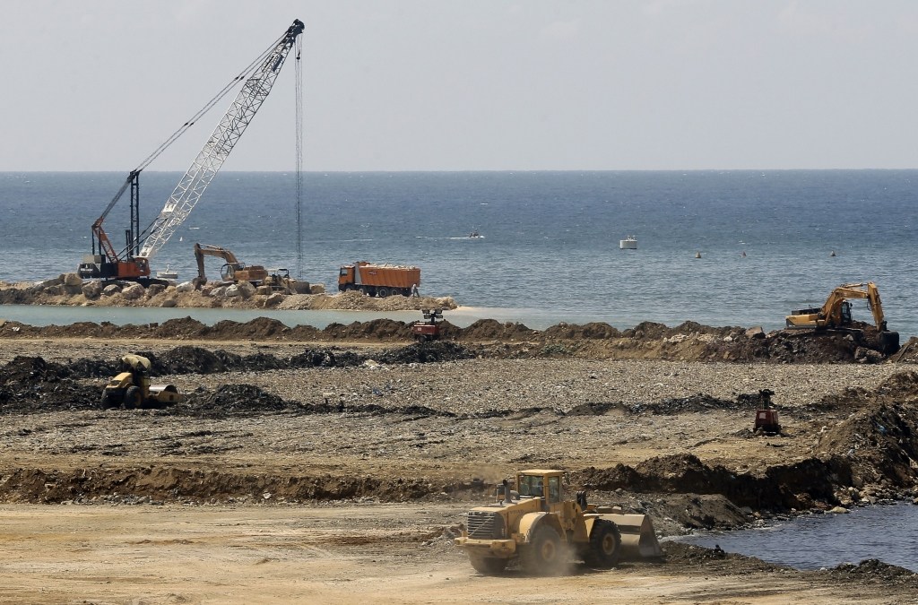 Trucks and bulldozers tip rubbish into the Mediterranean Sea at Borj Hammoud, in Lebanon. (Joseph Eid / AFP)