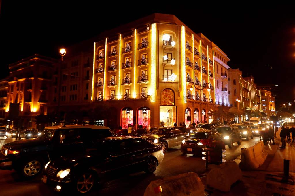 Vehicles drive past Christmas lights in Beirut. (JOSEPH EID / AFP)